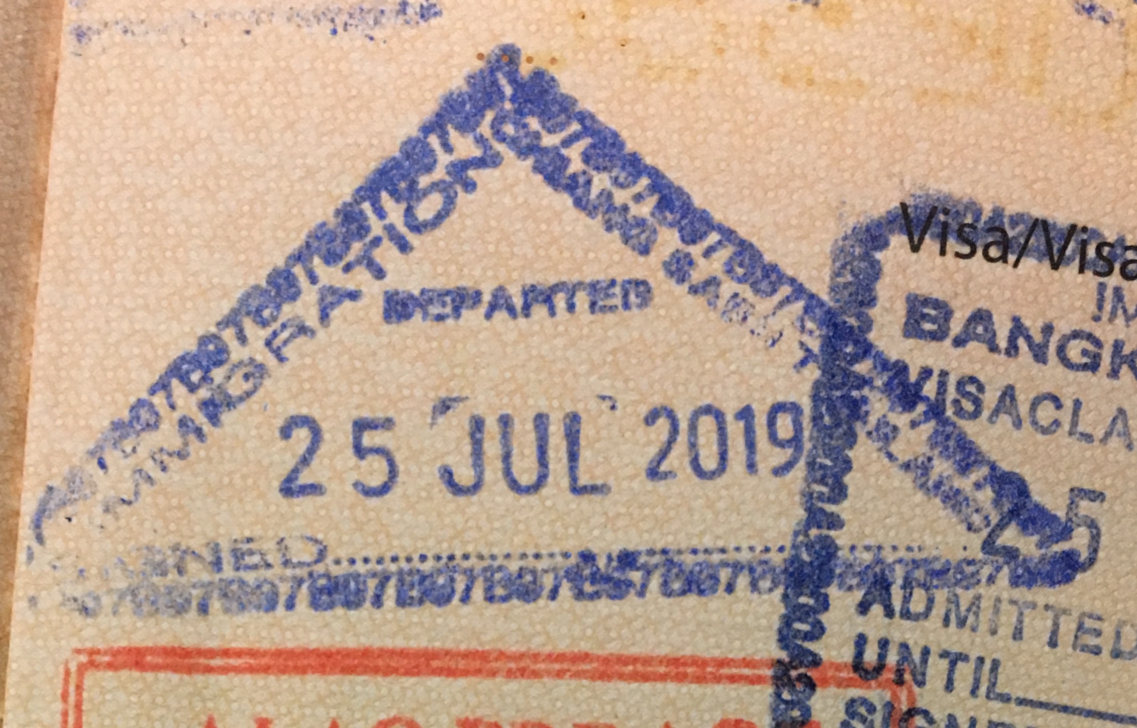 Thai immigration officer stamping a passport